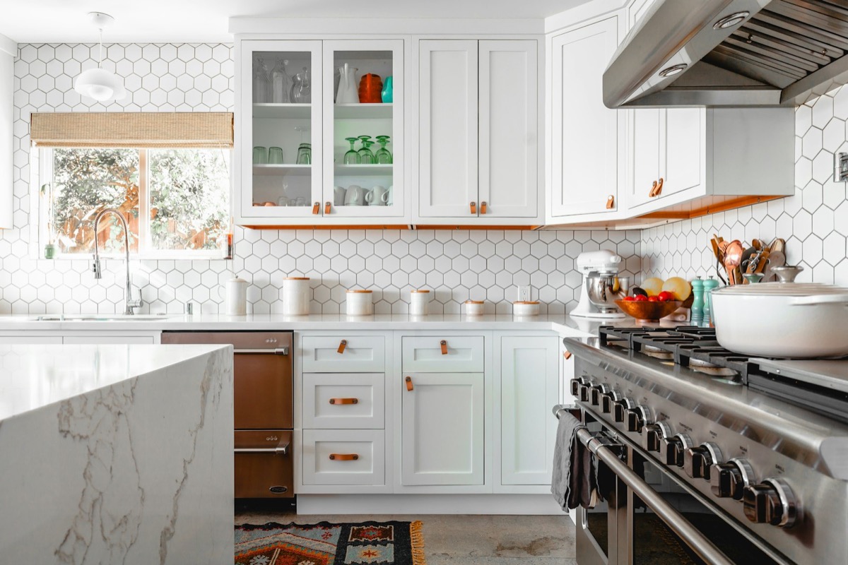 White modular kitchen with marble island